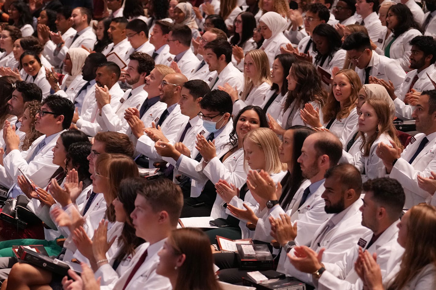 Medical students applaud during the University of Minnesota Medical School's annual White Coat Ceremony for the class of 2026 Friday, Aug. 19, 2022 at the Northrop Memorial Auditorium on the University campus in Minneapolis. The Class of 2026 on the Twin Cities Campus includes 167 students with half of them Black, Indigenous and people of color. ] ANTHONY SOUFFLE • anthony.souffle@startribune.com