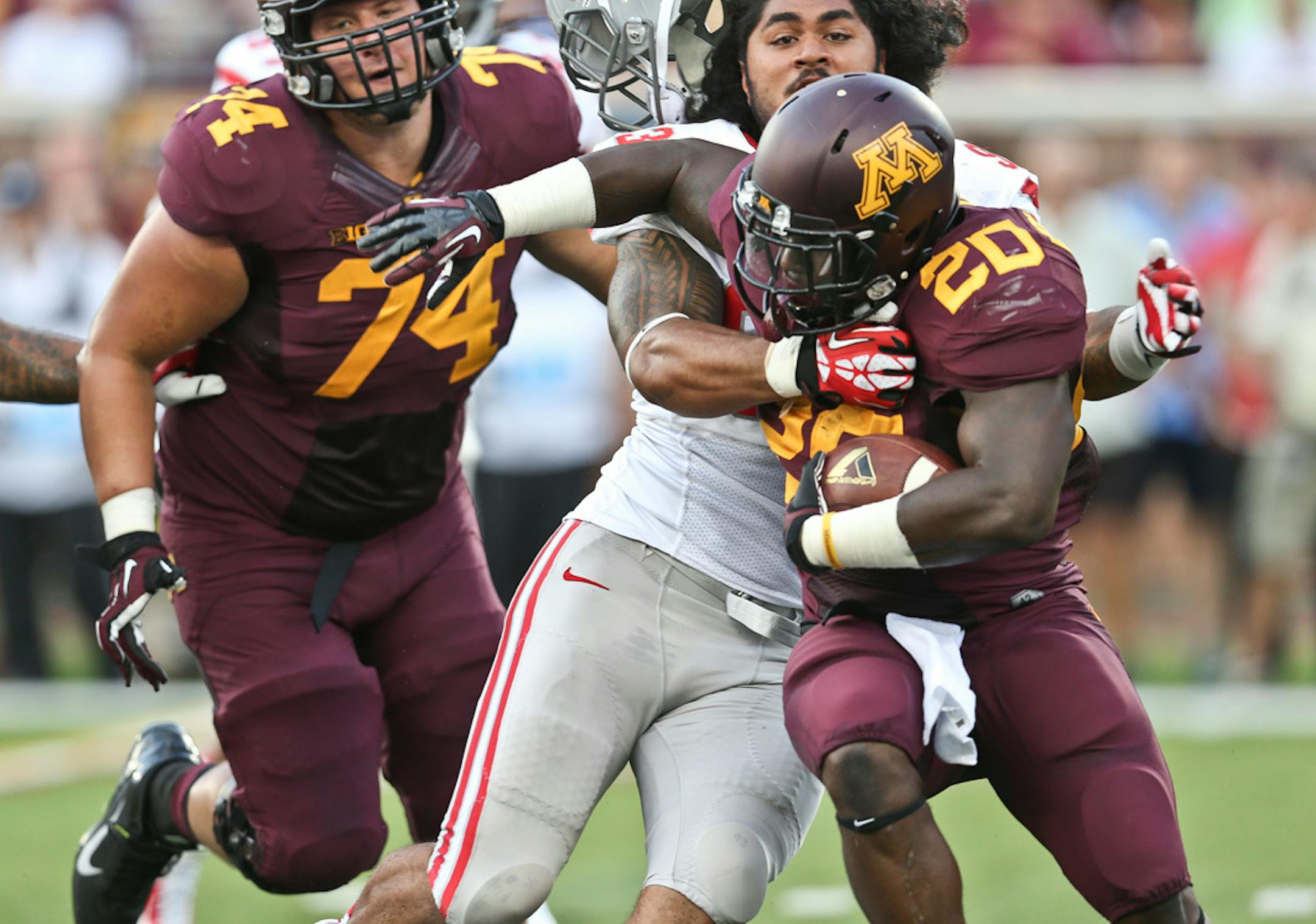 UNLV Rebels defensive lineman Sonny Sanitoa (93) dragged Minnesota Golden Gophers running back Donnell Kirkwood (20) back for a four yard loss on the play in the second quarter during the Minnesota Gophers vs. UNLV in the season opener at TCF Bank Stadium at the University of Minnesota in Minneapolis, Minn., on Thursday, August 29, 2013. ] (RENEE JONES SCHNEIDER • reneejones@startribune.com)