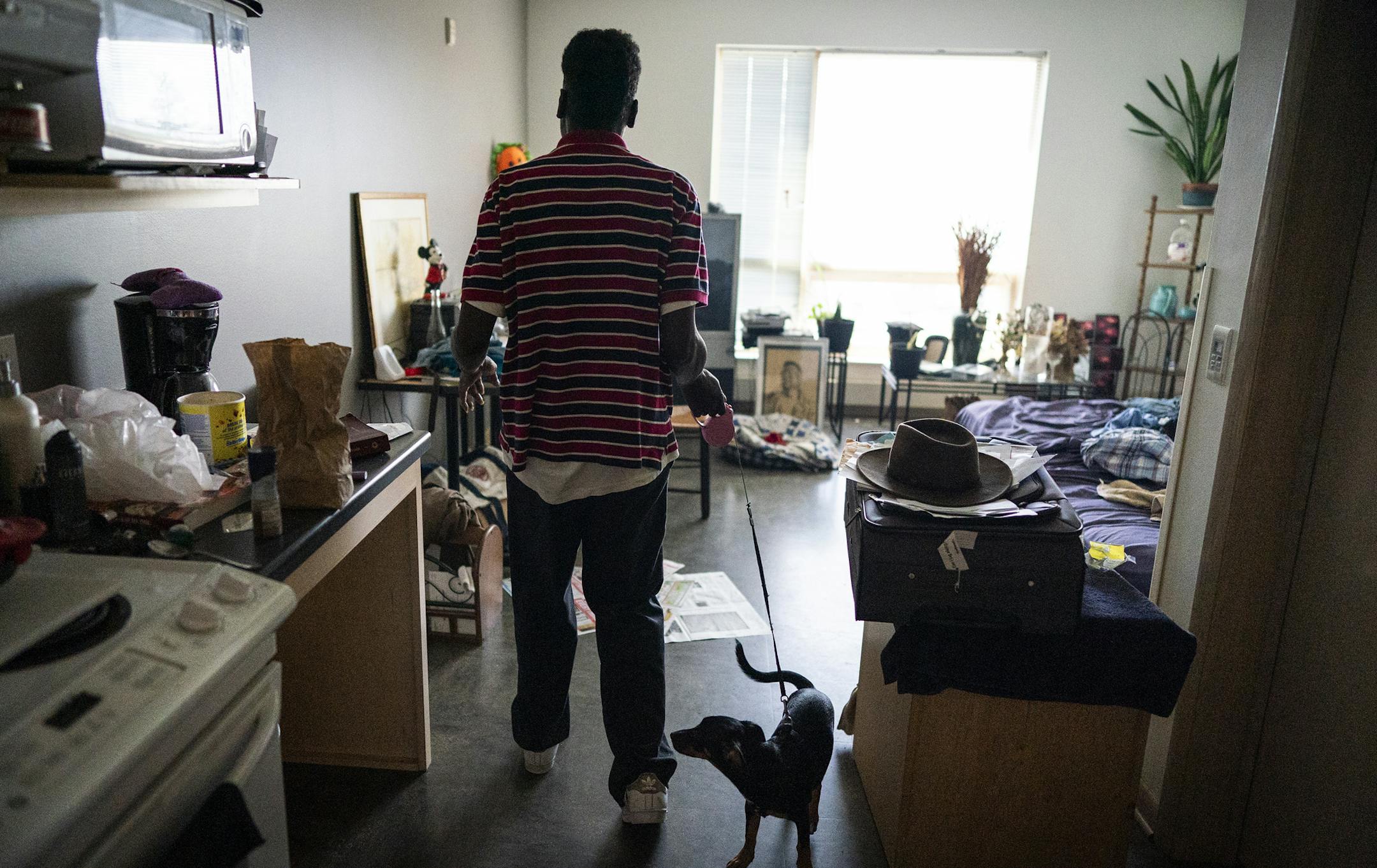 Ray Brooks walked inside his home in Clare Housing Midtown with his dog Tori Tornado, a chihuahua and terrier mix. ] LEILA NAVIDI • leila.navidi@startribune.com BACKGROUND INFORMATION: Ray Brooks, who is HIV positive, is a resident of Clare Housing Midtown in Minneapolis on Wednesday, August 21, 2019. Clare Housing, a supportive housing community for people living with HIV, is receiving funding from the Department of Housing and Urban Development for more than $951,000.