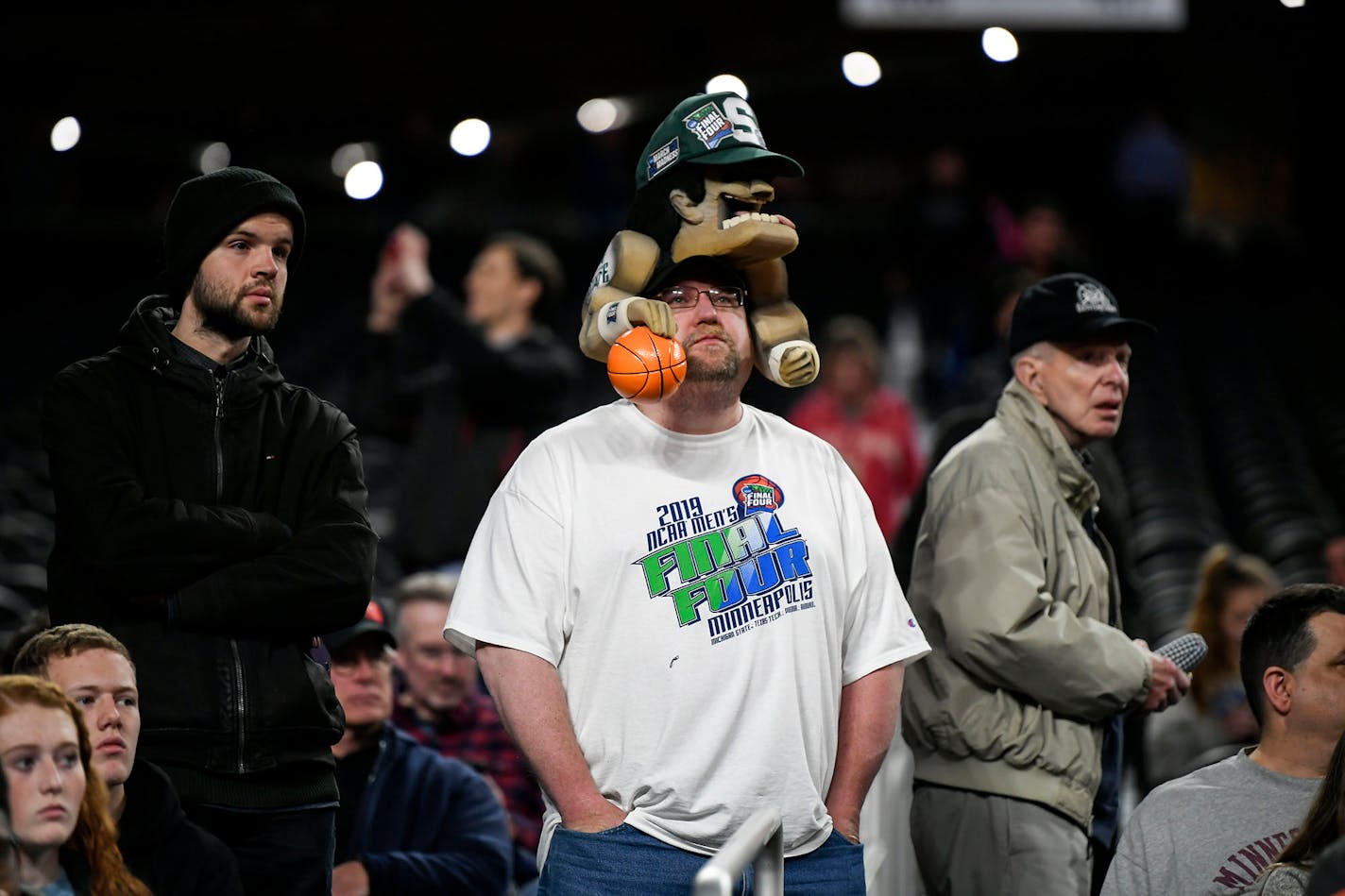 Michigan State fan Nate Lauber of Fon du Lac, Wis., center, took in the scene at U.S. Bank Stadium Friday the day before Final Four play begins.