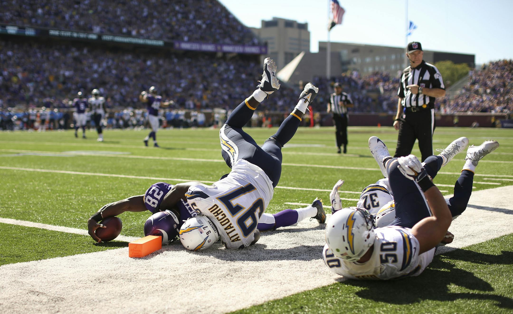 Vikings running back Adrian Peterson (28) nearly scored on an 11 yard run to the San Diego one yard line in the third quarter Sunday afternoon. He was brought down by Chargers outside linebacker Jeremiah Attaochu (97) just short of the goal line. ] JEFF WHEELER &#xef; jeff.wheeler@startribune.com The Minnesota Vikings beat the San Diego Chargers 31-14 in an NFL football game Sunday afternoon, September 27, 2015 at TCF Bank Stadium in Minneapolis.