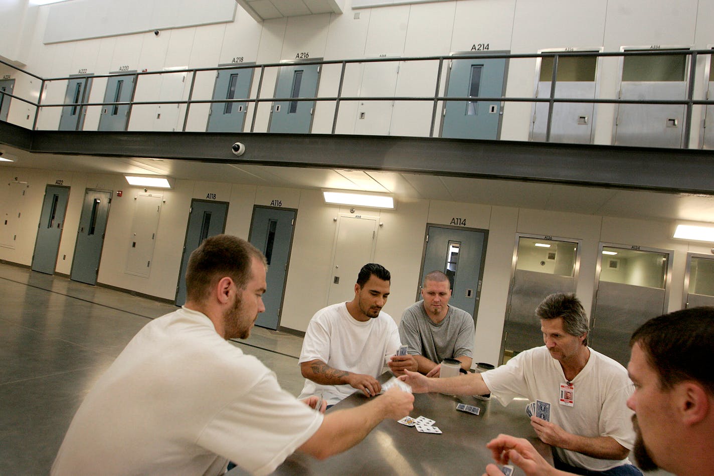 Inmates took a break from janitorial work to play cards in one of three new housing units built on the Faribault prison grounds. The state is investing $133 million to retrofit the prison, a former mental hospital, to hold as many as 2,500 medium-security inmates.