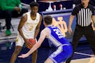 Notre Dame's Trey Wertz (2) holds the ball as Duke's Matthew Hurt (21) defends during an NCAA college basketball game Wednesday, Dec. 16, 2020, in Sou