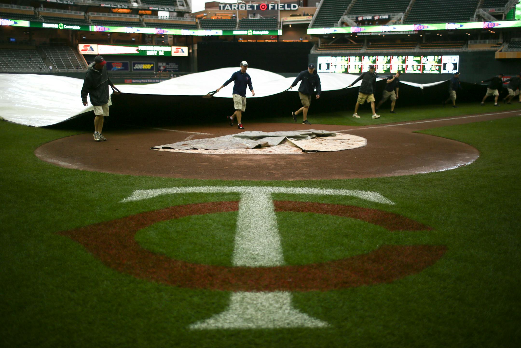 The Minnesota Twins faced the Boston Red Sox in an game Sunday afternoon, May 19, 2013 at Target Field in Minneapolis. The grounds crew started getting the tarp off the field after the rain let up and the game could resume.