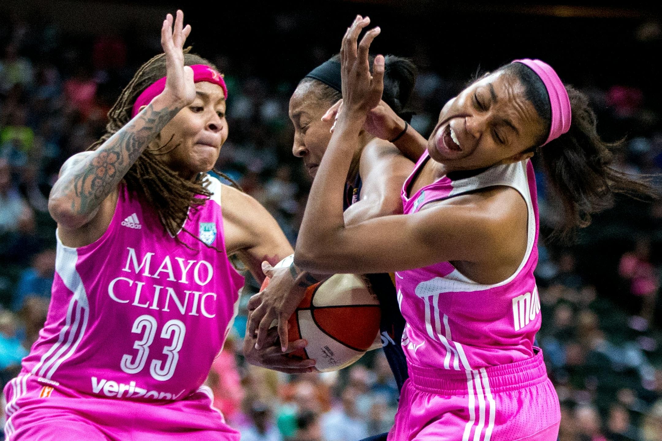 Minnesota Lynx guard Renee Montgomery (21) gets pushed back after being fouled by Indiana Fever�s Briann January (20) while Lynx guard Seimone Augustus (33) tries to steal the ball during the second half on Friday, Aug. 18, 2017, at Xcel Energy Center.