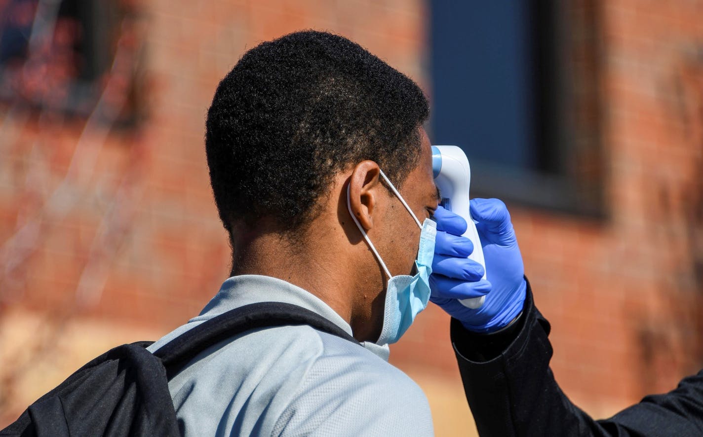 Jacori Hayes of Minnesota United had his temperature taken during a voluntary workout Tuesday at the National Sports Center in Blaine. Sports reporters and photographers were not allowed to be present. Even coaches and staff only watched from a distance.