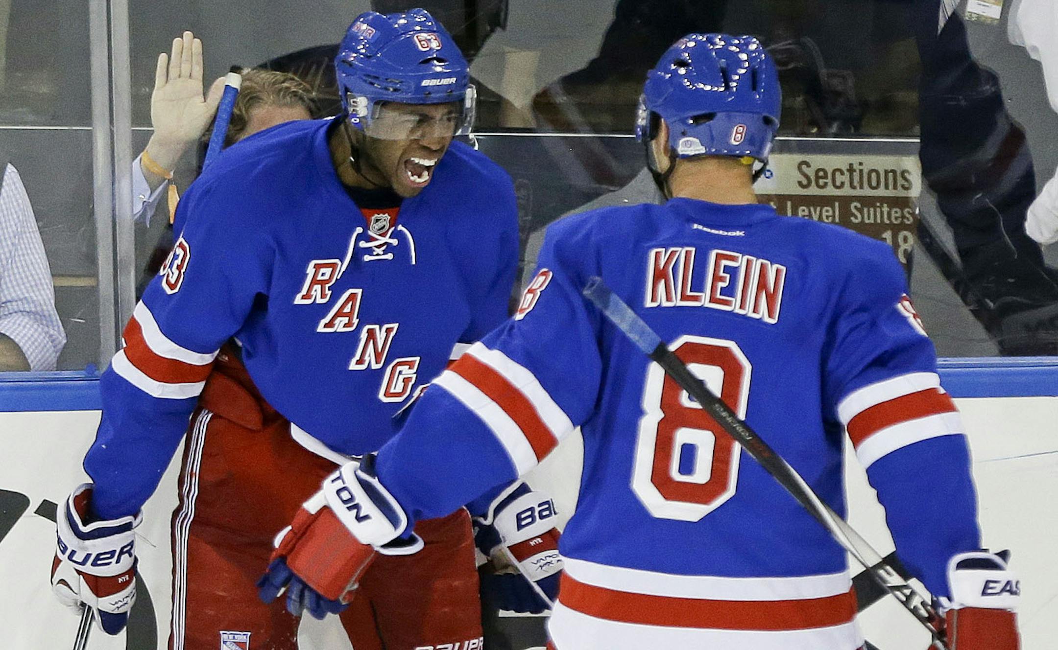 New York Rangers left wing Anthony Duclair (63) celebrates his first career goal with Kevin Klein (8) during the third period of an NHL hockey game against the Minnesota Wild, Monday, Oct. 27, 2014, in New York. The Rangers won the game 5-4. (AP Photo/Frank Franklin II)