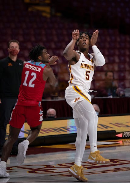 Minnesota Gophers guard Marcus Carr (5) watched his game winning three pointer drop with just second left in the game.