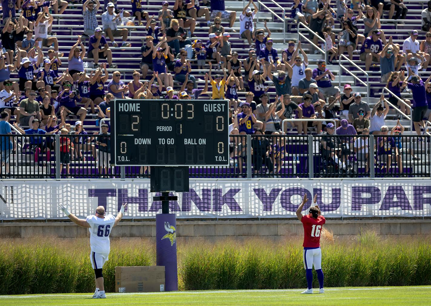 Vikings players Alan Ali (66) and Jaren Hall (16) led fans in the "Skol" chant during practice Monday in Eagan.