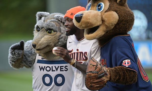 Minnesota Timberwolves point guard Patrick Beverley posed with Crunch and TC Bear after he threw out the ceremonial first pitch Wednesday night. ] AAR