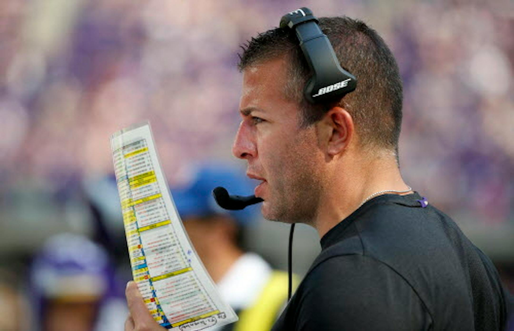 FILE - In this Sept. 23, 2018, file photo, Minnesota Vikings offensive coordinator John DeFilippo looks at his play sheet during the second half of an NFL football game against the Buffalo Bills, in Minneapolis. DeFilippo has been scheming this week on how to beat the Eagles, the team he won a Super Bowl with as quarterbacks coach last season. The trip will be even more poignant than that, because Philadelphia is where DeFilippo grew up.  (AP Photo/Bruce Kluckhohn, File)