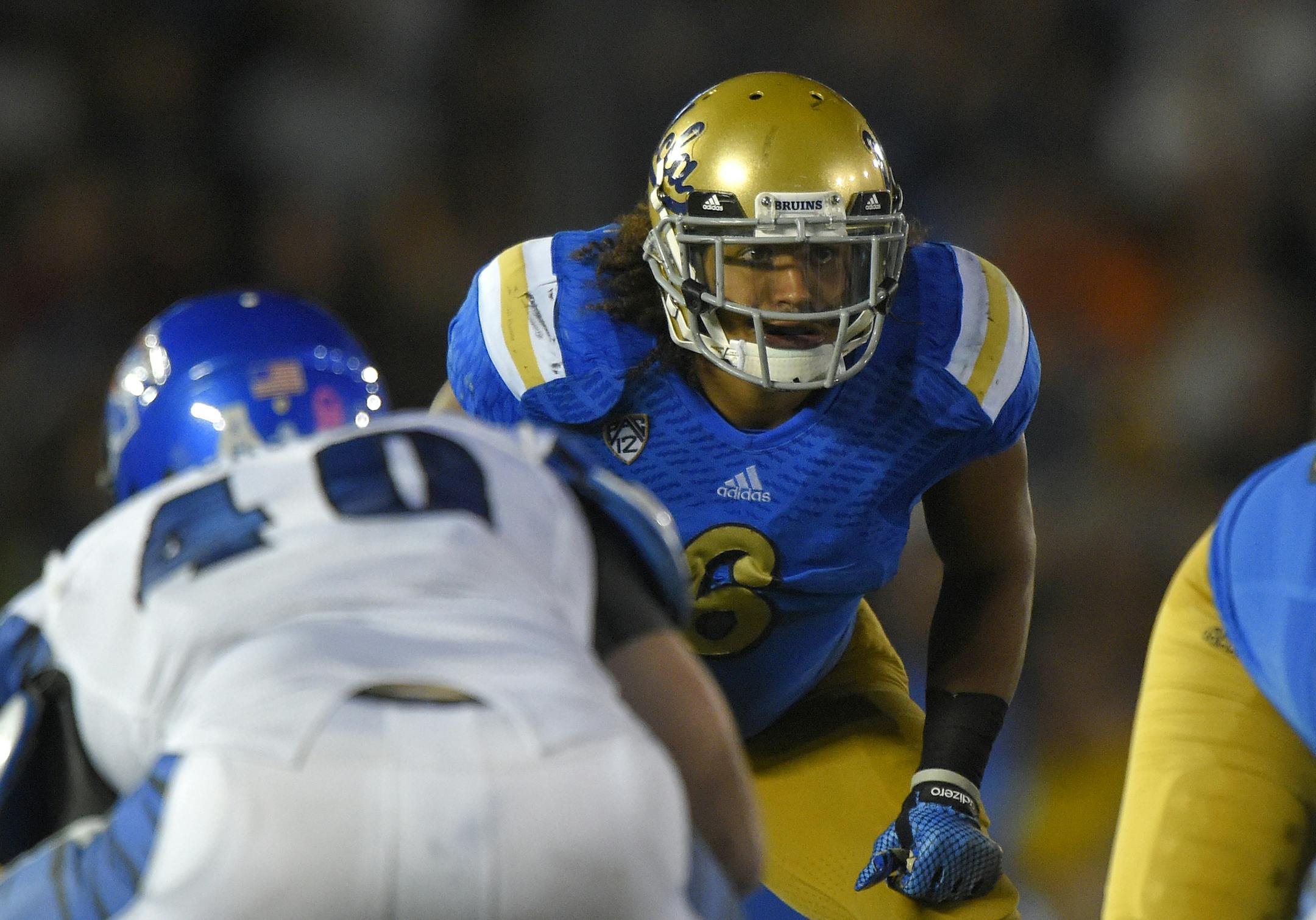 UCLA linebacker Eric Kendricks, right, waits for the snap along with Memphis tight end Alan Cross during the second half of an NCAA college football game, Saturday, Sept. 6, 2014, in Pasadena, Calif. UCLA won 42-35. (AP Photo/Mark J. Terrill) ORG XMIT: NYOTK