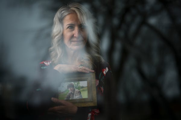 Dawn Saxton holds a photo of her son, Gavin, at her home in Fergus Falls. Gavin, 27, has schizophrenia and is currently in the Otter Tail County Jail.