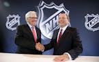 NHL Commissioner Gary Bettman, right, and Bill Foley pose for photographers during a news conference Wednesday, June 22, 2016, in Las Vegas. Bettman a