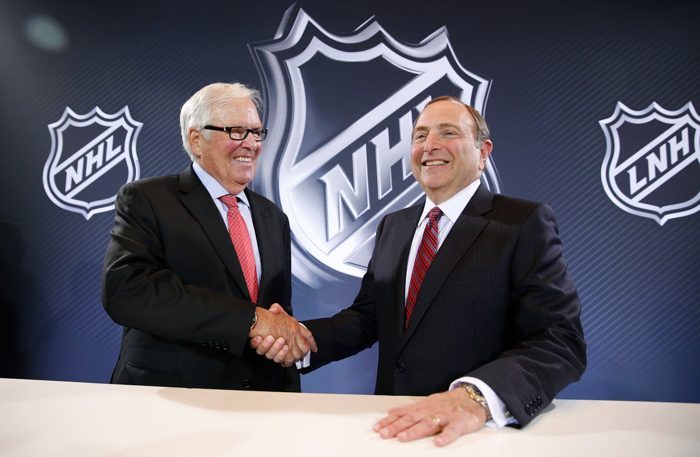 NHL Commissioner Gary Bettman, right, and Bill Foley pose for photographers during a news conference Wednesday, June 22, 2016, in Las Vegas. Bettman announced an expansion franchise to Las Vegas after the league's board of governors met in Las Vegas. Foley is the majority owner of the team. (AP Photo/John Locher)