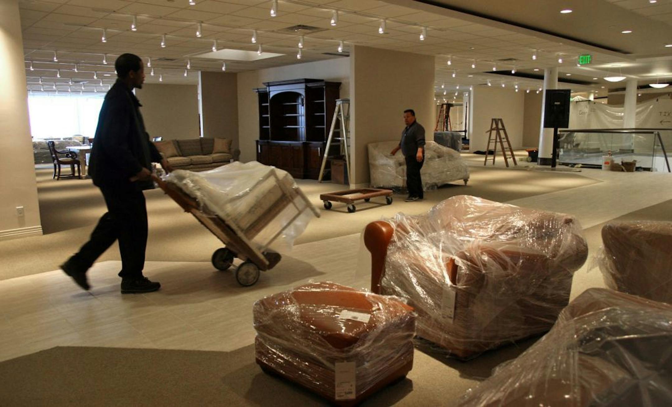 TOM SWEENEY � tsweeney@startribune.com Edina, MN 2/05/2007 Gabberts employees Jason Hayes, (l) and Gus Martinez (r) wheel in pieces of furniture to the new 63,000 sq ft showroom in the Galleria. the new section opening later this month replaces administrative offices.