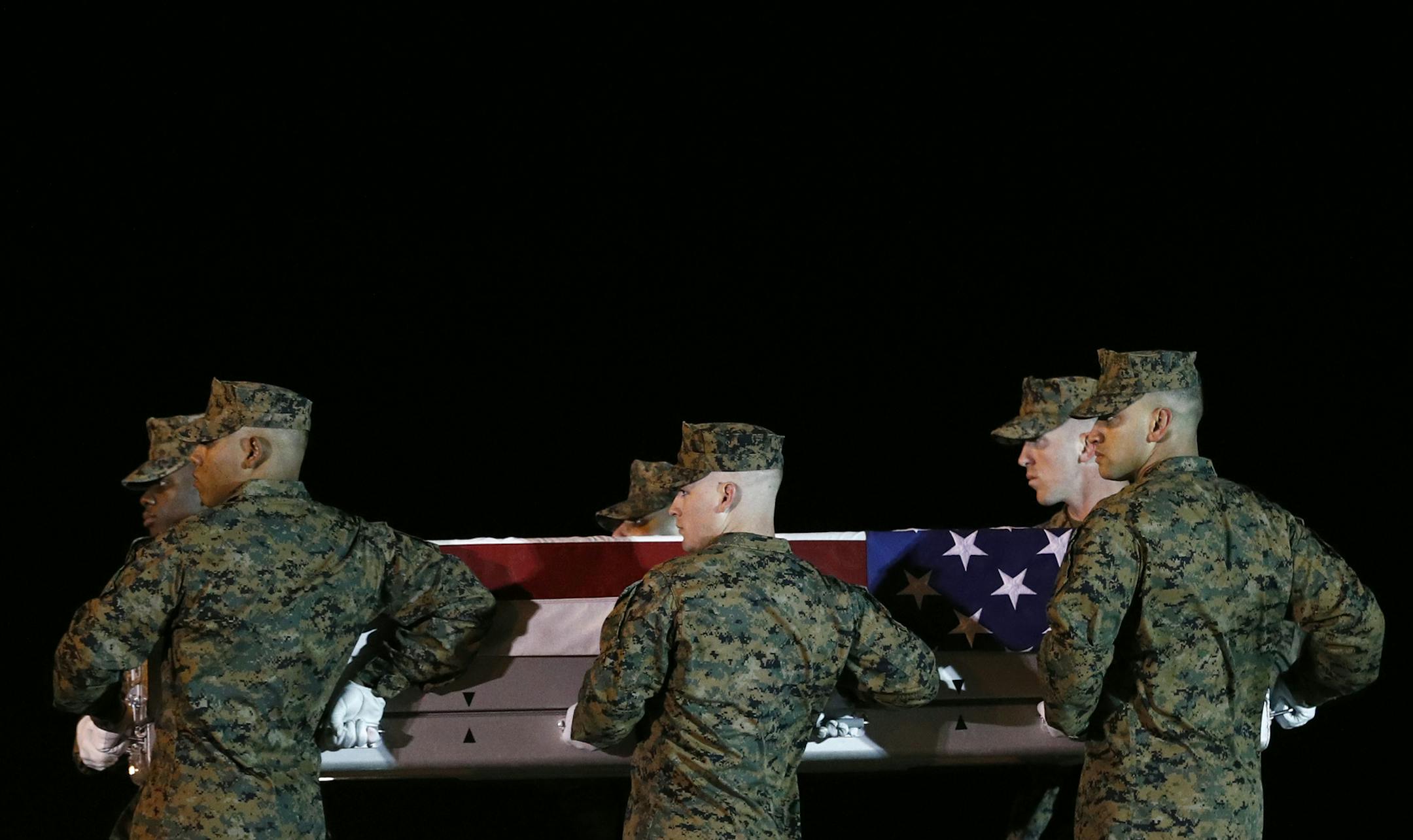 A U.S. Marine Corps carry team moves a transfer case containing the remains of Staff Sgt. Christopher Slutman, Thursday, April 11, 2019, at Dover Air Force Base, Del. According to the Department of Defense, Slutman, of Newark, Del., was among three American service members killed by a roadside bomb on Monday, April 8, near Bagram Airfield in Afghanistan. (AP Photo/Patrick Semansky) ORG XMIT: DEPS103