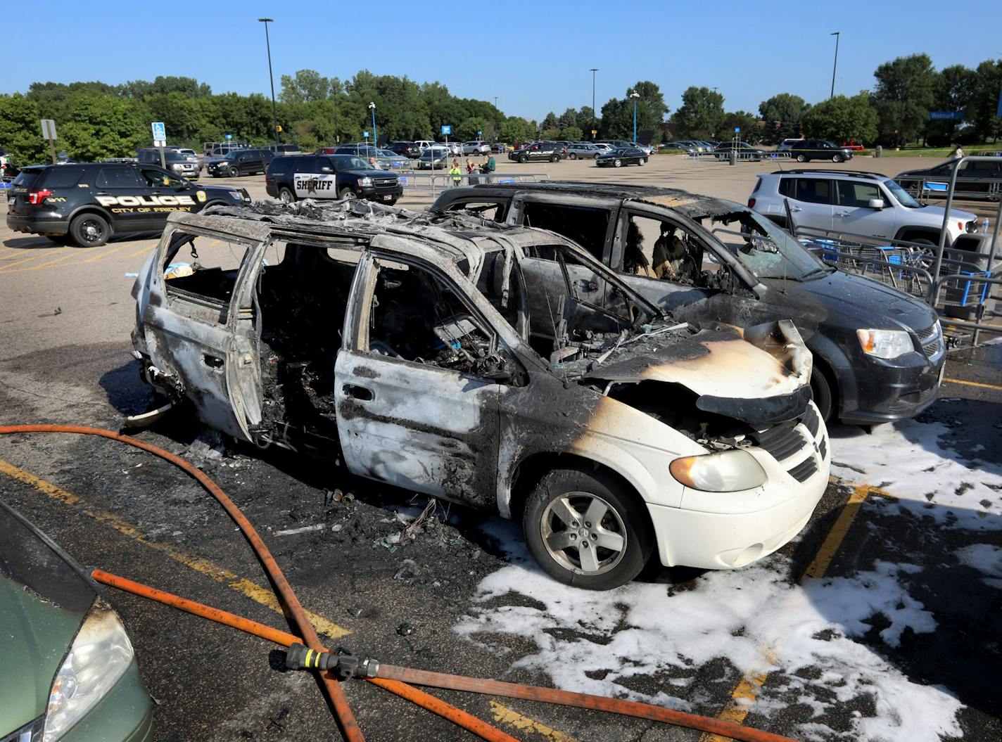 A car fire at a Fridley Walmart engulfed three vehicles and left two young passengers injured in a taxi van parked next to the vehicle where the fire originated Tuesday, Aug. 6, 2019, in Fridley, MN. Two of three vehicles charred in in car fire where two children were injured, one critically.