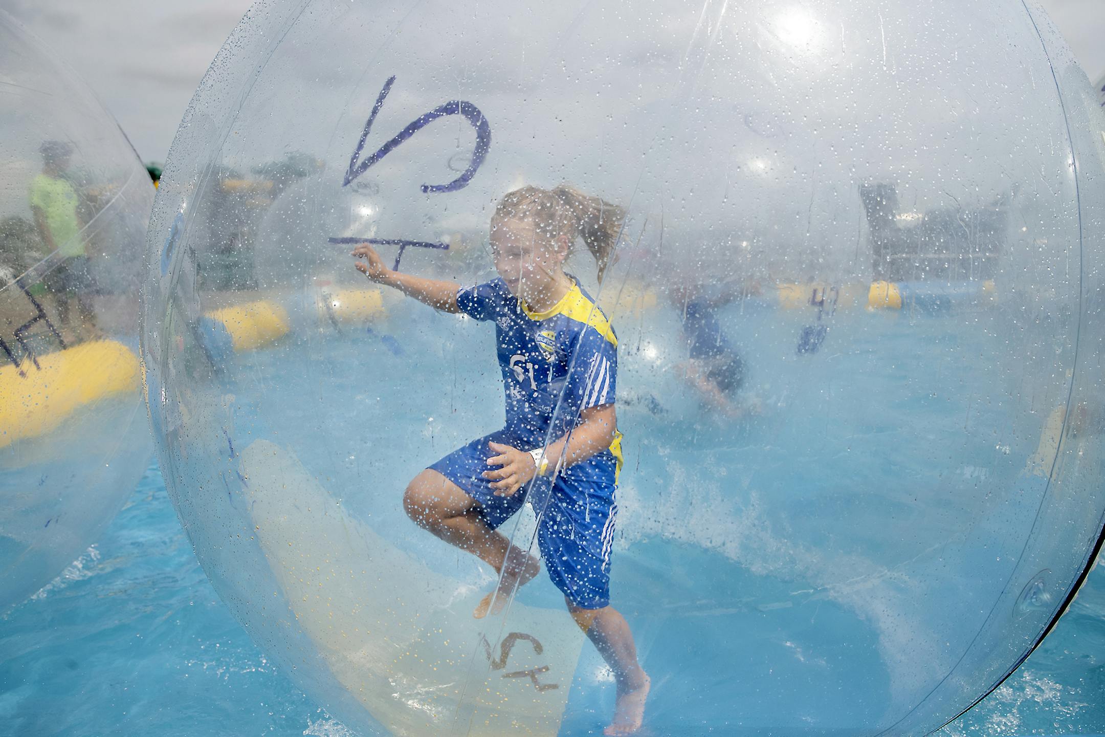 Henry Krych, 10, took refuge from the heat in a bubble pool after his soccer game at the at National Sports Center during the USA Cup soccer tournament, Tuesday, July 16, 2019 in Blaine, MN. ] ELIZABETH FLORES • liz.flores@startribune.com