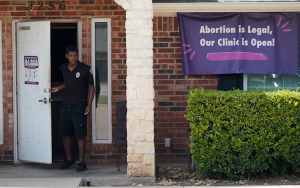 A security guard opens the door to the Whole Women's Health Clinic in Fort Worth, Texas, Wednesday, Sept. 1, 2021. A Texas law banning most abortions 