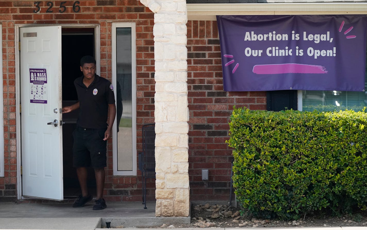 A security guard opens the door to the Whole Women's Health Clinic in Fort Worth, Texas, Wednesday, Sept. 1, 2021. A Texas law banning most abortions in the state took effect at midnight, but the Supreme Court has yet to act on an emergency appeal to put the law on hold. If allowed to remain in force, the law would be the most dramatic restriction on abortion rights in the United States since the high court's landmark Roe v. Wade decision legalized abortion across the country in 1973. (AP Photo/LM Otero)