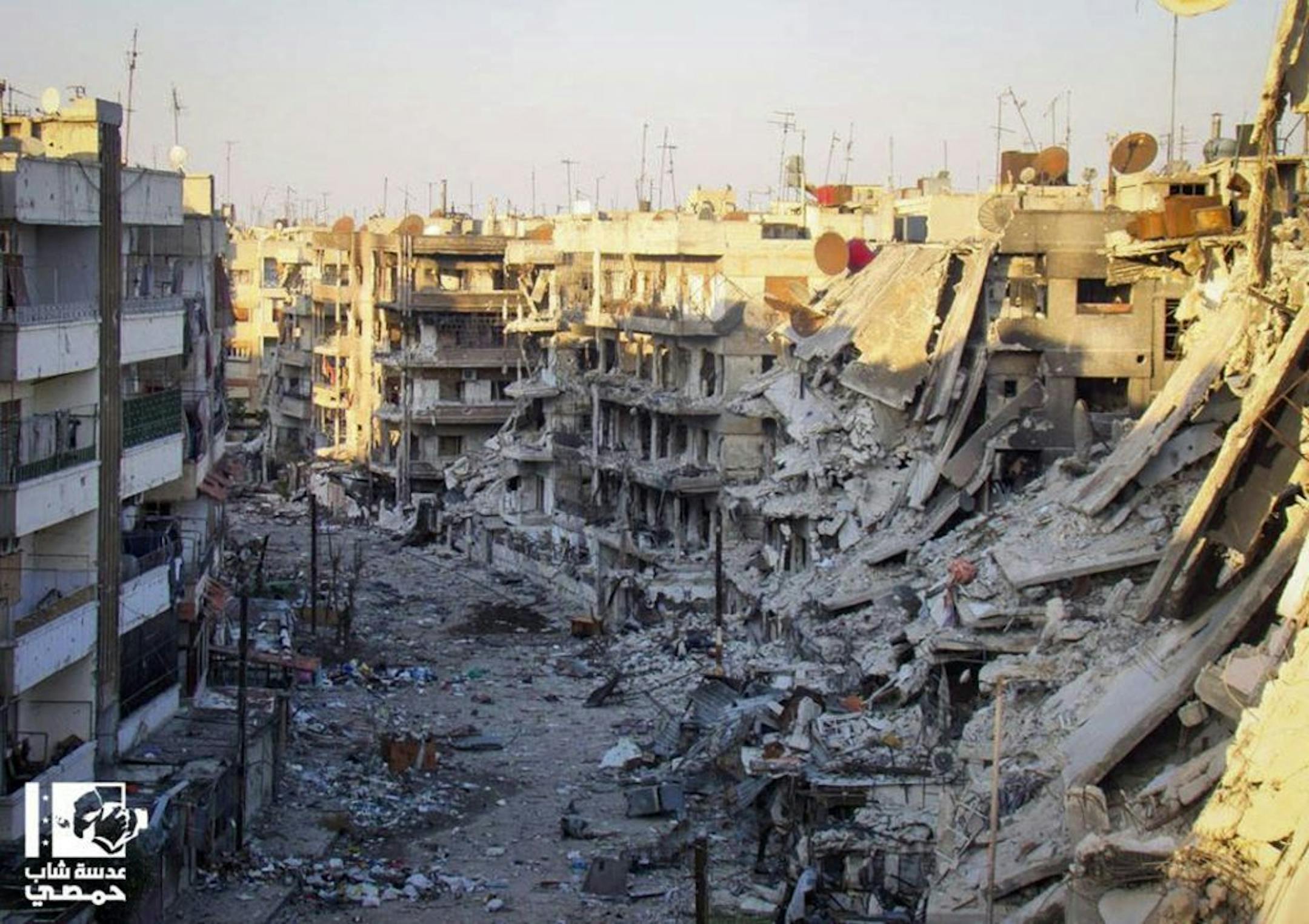 In this picture taken on Wednesday Oct. 31, 2012, a citizen journalism image provided by Lens Young Homsi, which has been authenticated based on its contents and other AP reporting, buildings which were destroyed from the shelling by Syrian forces loyal to Syrian president Bashar Assad, at al-Qossour neighborhood in Homs province, central Syria. Syrian warplanes fired missiles at opposition strongholds around Damascus and in the north on Wednesday as Turkey, a key backer of the anti-regime rebel