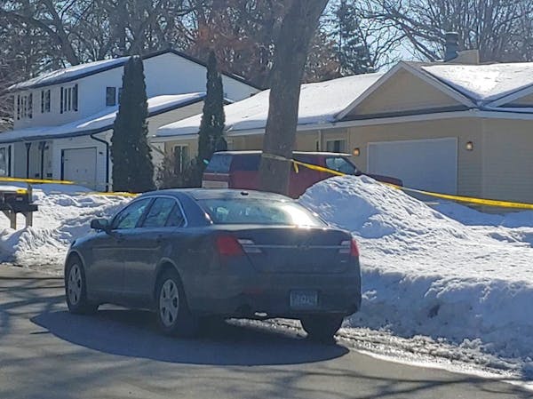Crime scene tape surrounded the yellow home where a man was fatally shot by Dakota County deputies serving a search warrant in Lakeville.