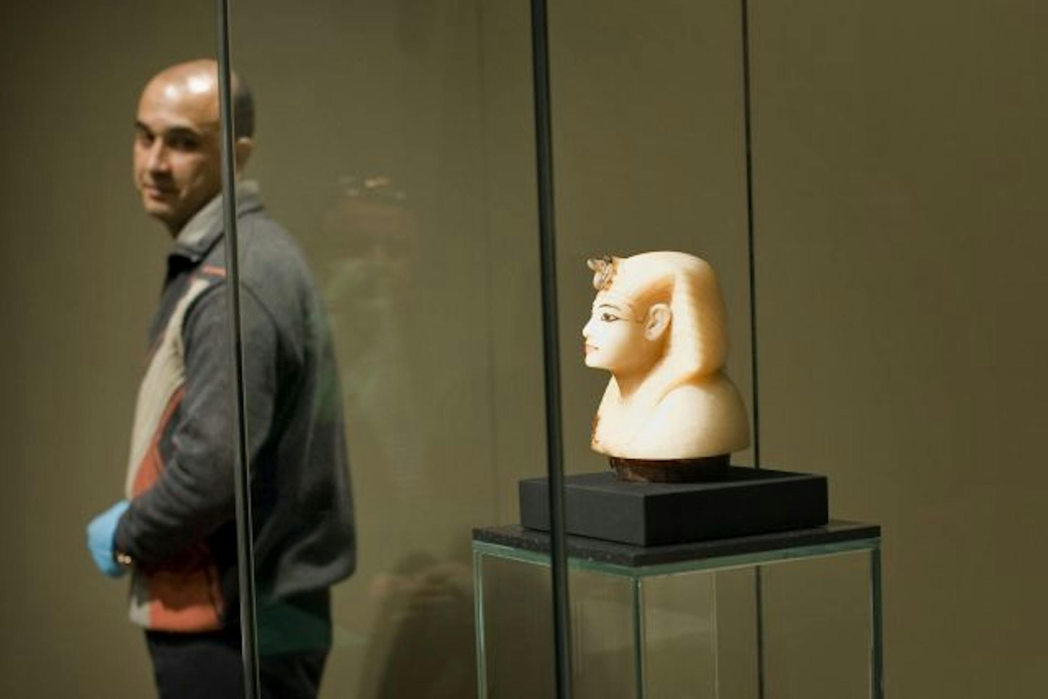 Sameh Abdelmonem, left, helped install a portrait head of Egypt's King Tutankhamun Thursday at the Science Museum of Minnesota.