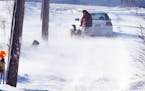 A strong westerly wind kicked up snow Sunday afternoon drifting it over area roads and parking lots. A St. Paul resident used a snow blower in an atte