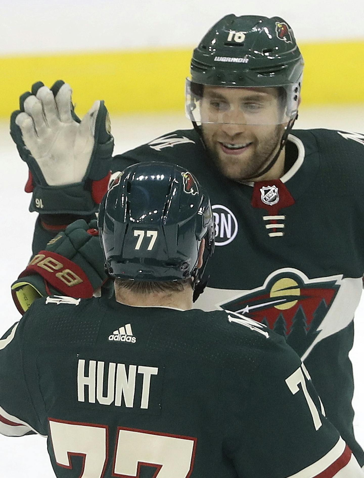 Minnesota Wild's Brad Hunt (77) and Jason Zucker (16) celebrate after Zucker scored against the Winnipeg Jets during the third period of an NHL hockey game Tuesday, Feb. 26, 2019, in Winnipeg, Manitoba. (Trevor Hagan/The Canadian Press via AP)