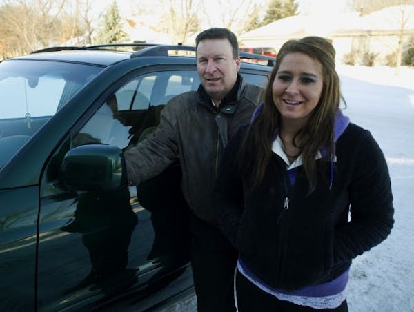 Jeff Hemauer and daughter Emily Hemauer with the car that got towed.