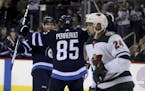 Winnipeg Jets' Joel Armia (40) and Mathieu Perreault (85) celebrate after Perreault scored during second period NHL hockey action against the Minnesot