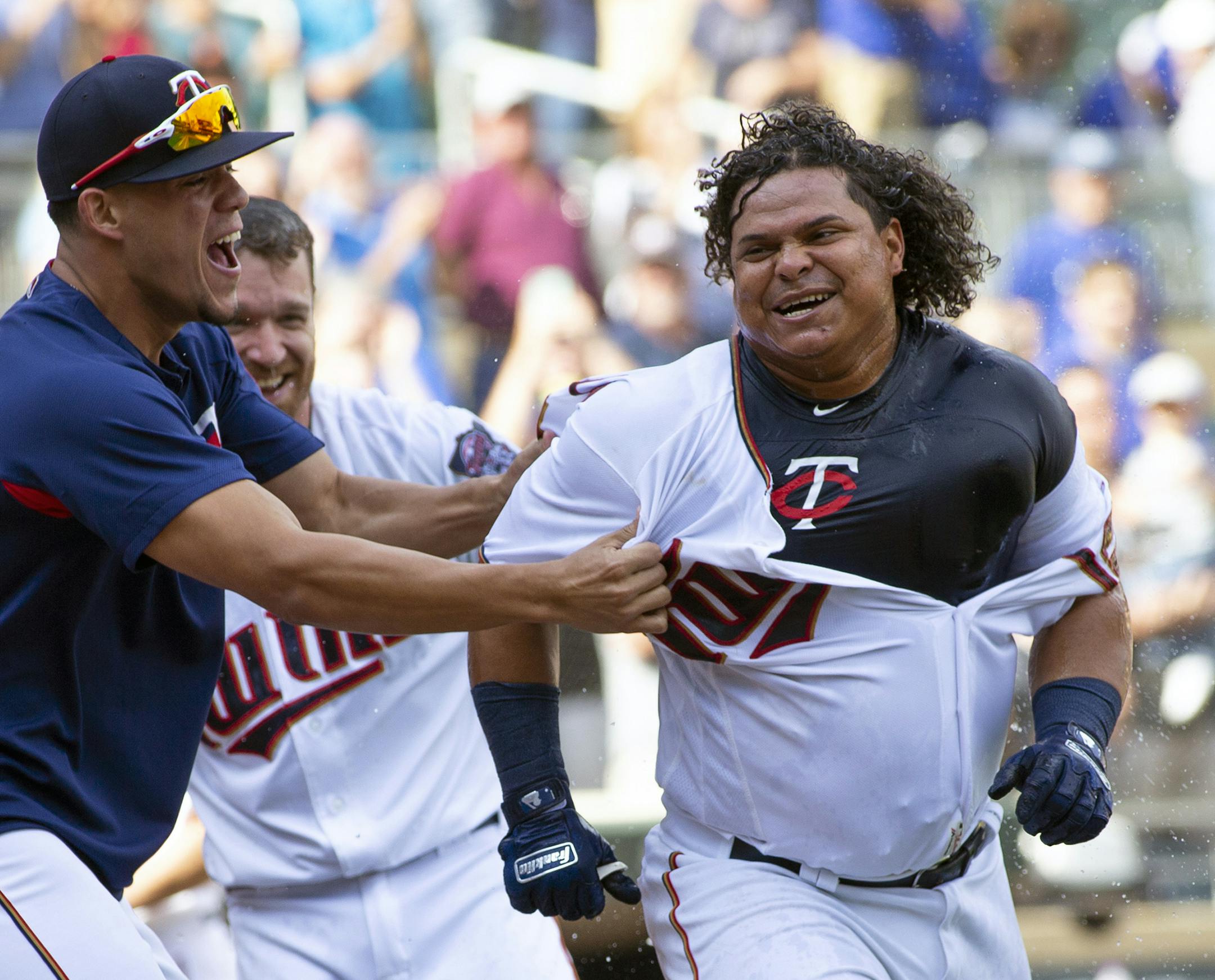 FILE - In this Sept. 9, 2018, file photo, Minnesota Twins' Willians Astudillo, right, is mobbed by teammate Jose Berrios after hitting a 2-run home run during the ninth inning of a baseball game against the Kansas City Royals, in Minneapolis. The most popular player on the first-place Minnesota Twins is the third-string catcher and versatile everyman Willians Astudillo, whose all-out style has endeared him to the team and the fans since his debut last season. His cult hero status reaches a new h