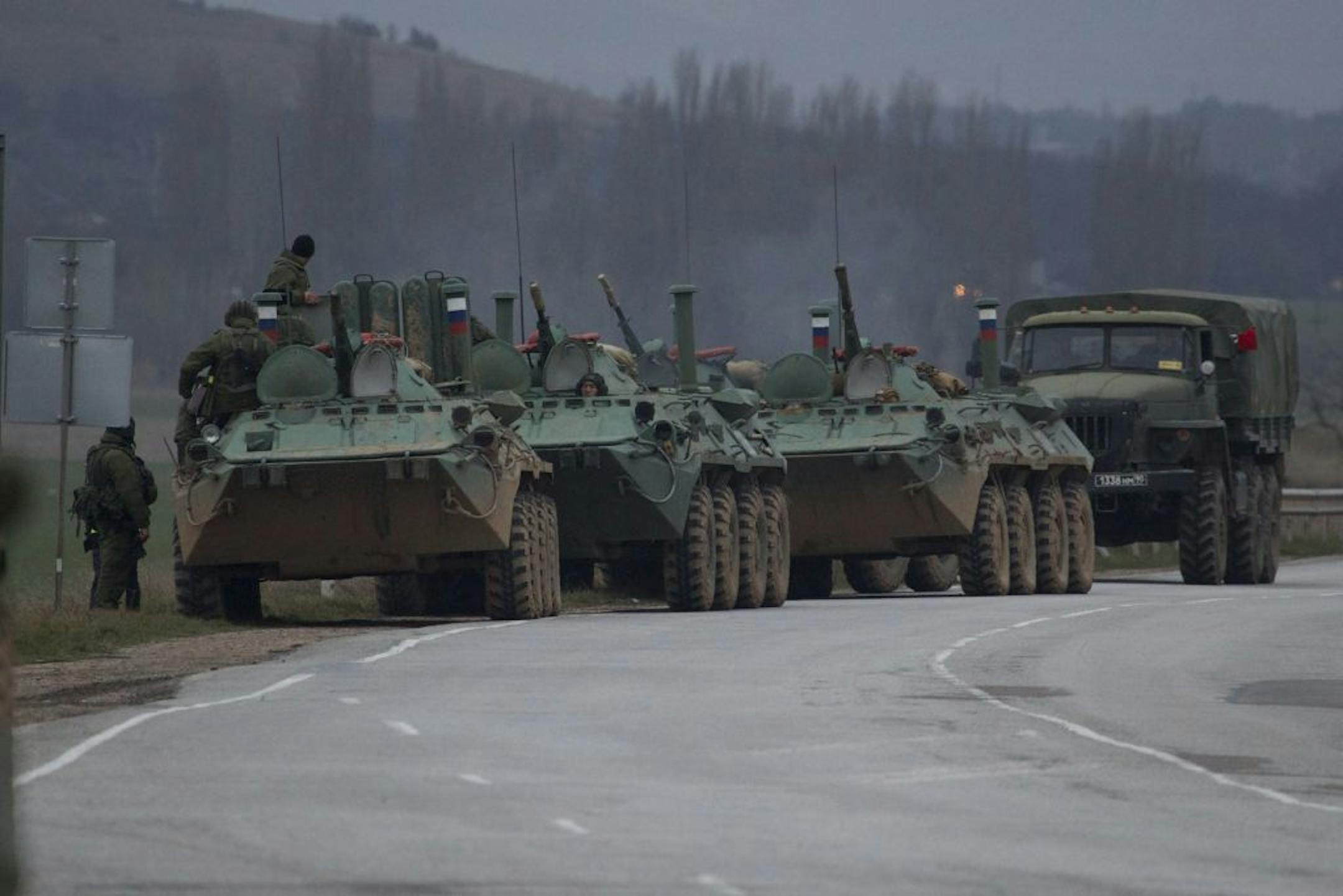 Russian armored personnel carriers and a truck are parked on the side of the road near the town of Bakhchisarai, Ukraine, Friday, Feb. 28, 2014. One of the vehicles apparently had mechanical problems.