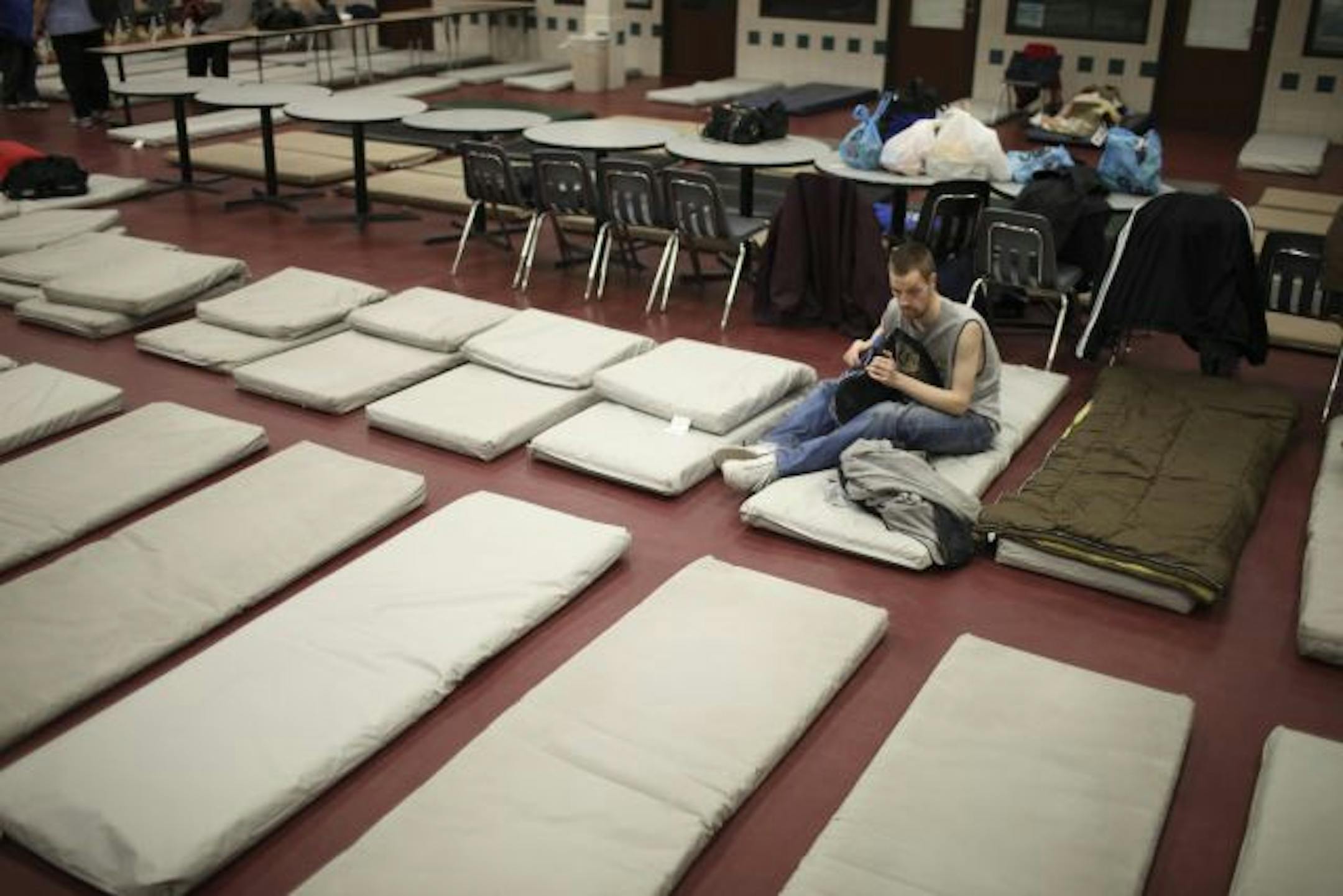 The emergency shelter at Dorothy Day Center in St. Paul has been crowding in 260 to 290 people a night, up about 40 percent from last year. Here, Craig Lee got settled on Monday. Health and social services there are provided by Health Care for the Homeless program, operated by West Side Community Health Services.