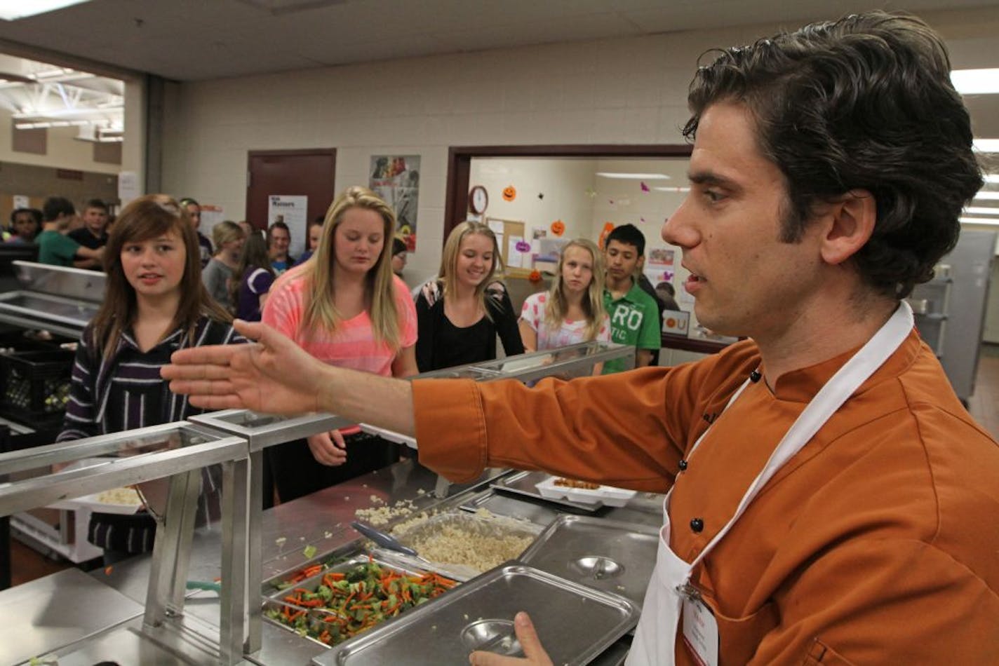 (right) Chef Marshall O'Brien urged students at Westwood Intermediate School in Blaine to scoop up fresh fruits and vegetables while getting lunch on 10/10/12. Some students are starting to rebel against the new school nutrition guidelines, claiming that the reduction of salt and fats has also reduced the taste of the meals and the caloric count that they require. Districts say the food is healthier and better for kids but will take time to get used to it. Chef Marshall O'Brien, who works with a