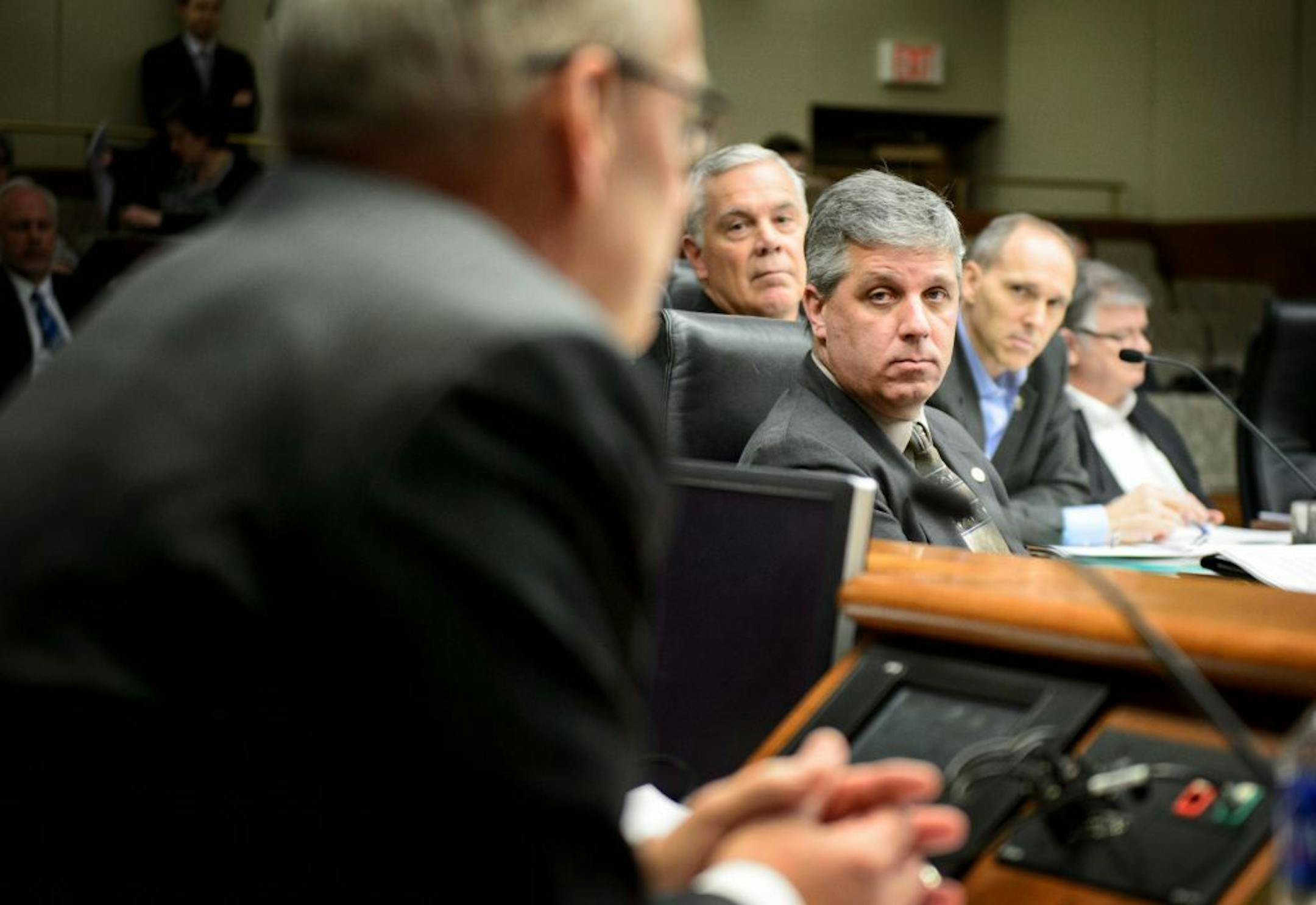 Minnesota Management and Budget Commissioner Myron Frans faced tough questioning from Rep. Steve Drazkowski, center, at the House Ways and Means Committee hearing about Governor Dayton's raises for commissioners. The committee approved Drazkowski's amendment that would reduce deficiency funding for state agencies by the amount of the raises approved for the commissioners of those agencies.