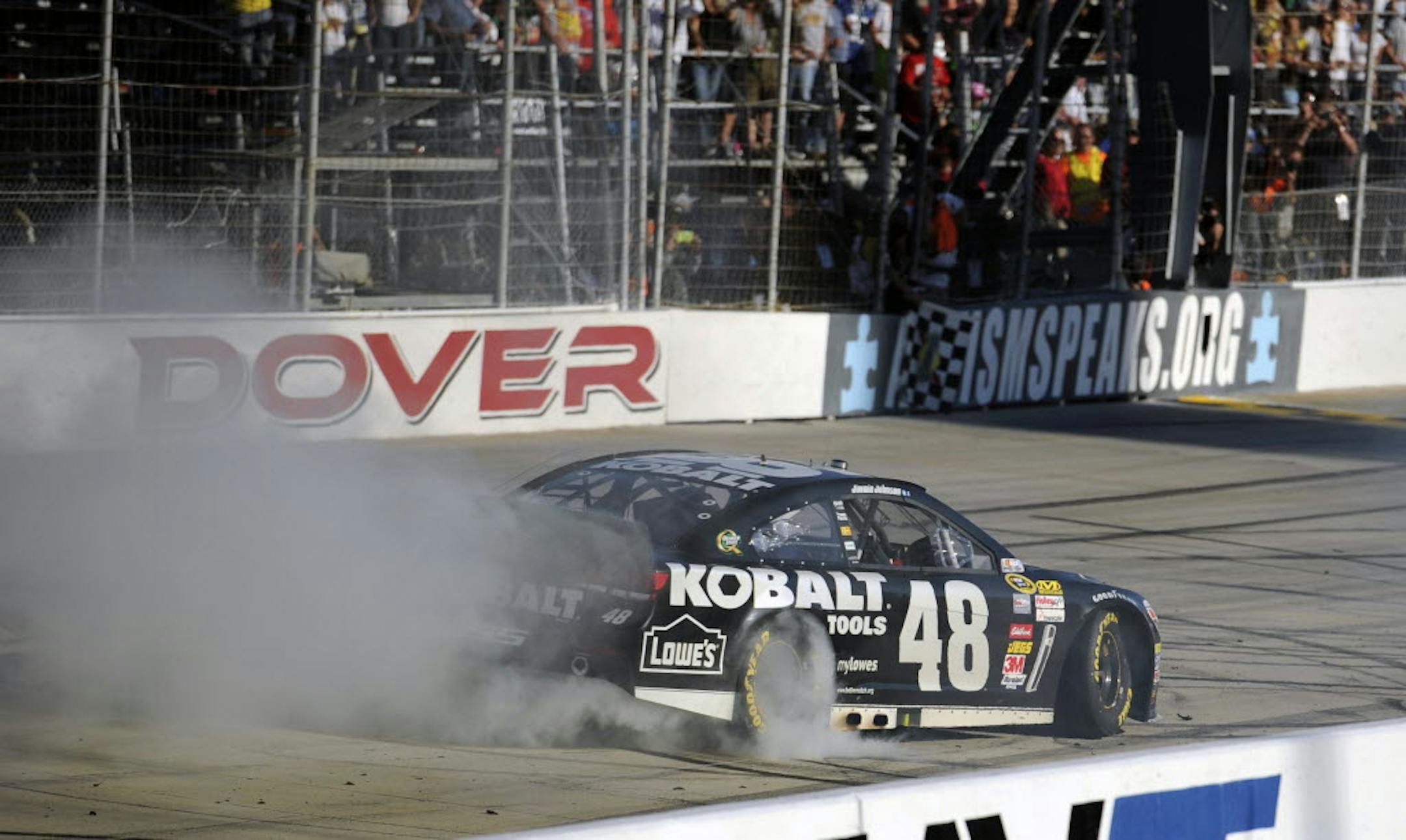 Jimmie Johnson performs a burnout after he won the NASCAR Sprint Cup Series race on Sunday, Sept. 29, 2013, at Dover International Speedway.