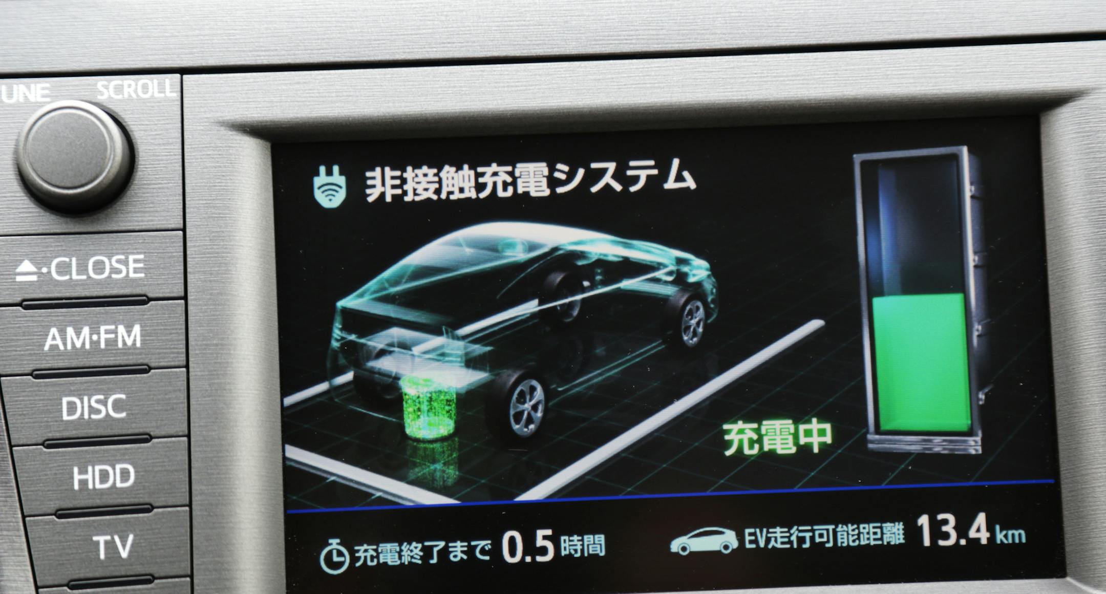 A monitor displays the charging status inside a Toyota Motor Corp. Prius PHV plug-in hybrid vehicle during a demonstration of the company's wireless vehicle charging system, which uses magnetic-resonance technology, in Toyota City, Aichi Prefecture, Japan, on Thursday, Feb. 13, 2014. The company has set a target of selling an unprecedented 10.32 million vehicles in 2014 after leading General Motors Co. and Volkswagen AG in global deliveries for a second straight year in 2013. Photographer: Yurik