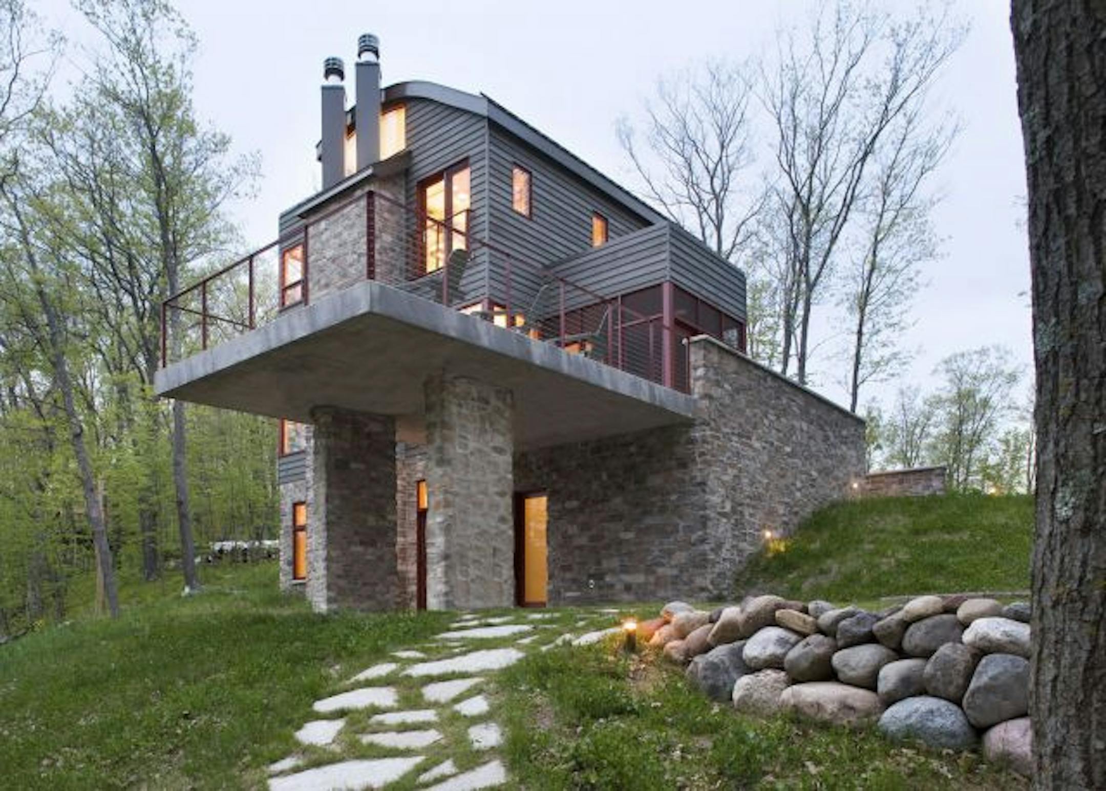 This shot at dusk shows the exterior of a lake home in Cumberland, Wis., desinged by SALA.