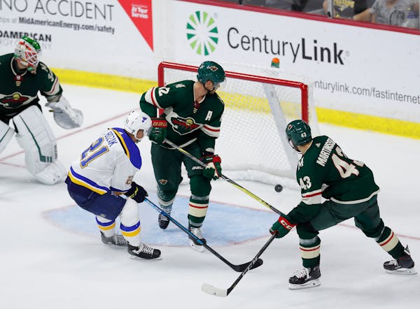 St. Louis Blues center Tyler Bozak (21) scores on an open goal as Wild center Eric Staal(12) and Eric Martinsson(43) attempt to defend Wednesday