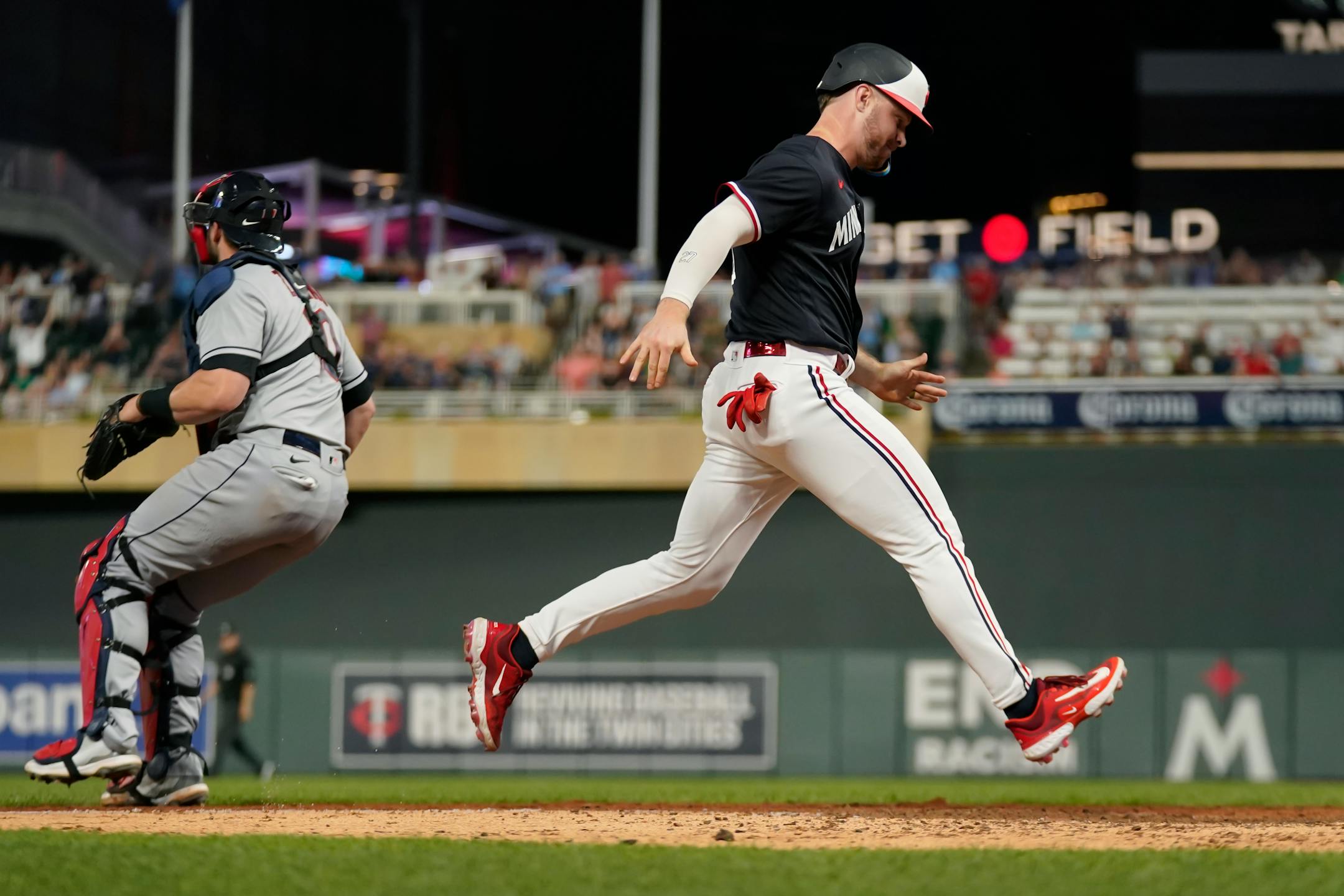Minnesota Twins pinch-runner Ryan Jeffers scores the winning run against the Cleveland Guardians during the ninth inning of a baseball game Thursday, June 1, 2023, in Minneapolis. (AP Photo/Abbie Parr)