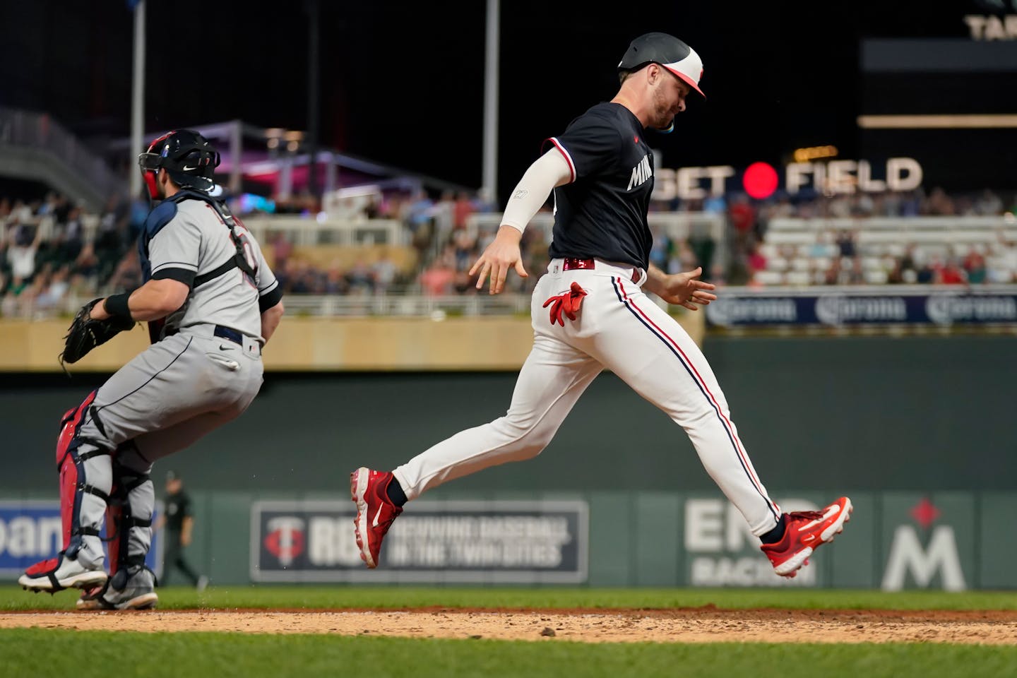 Minnesota Twins pinch-runner Ryan Jeffers scores the winning run against the Cleveland Guardians during the ninth inning of a baseball game Thursday, June 1, 2023, in Minneapolis. (AP Photo/Abbie Parr)