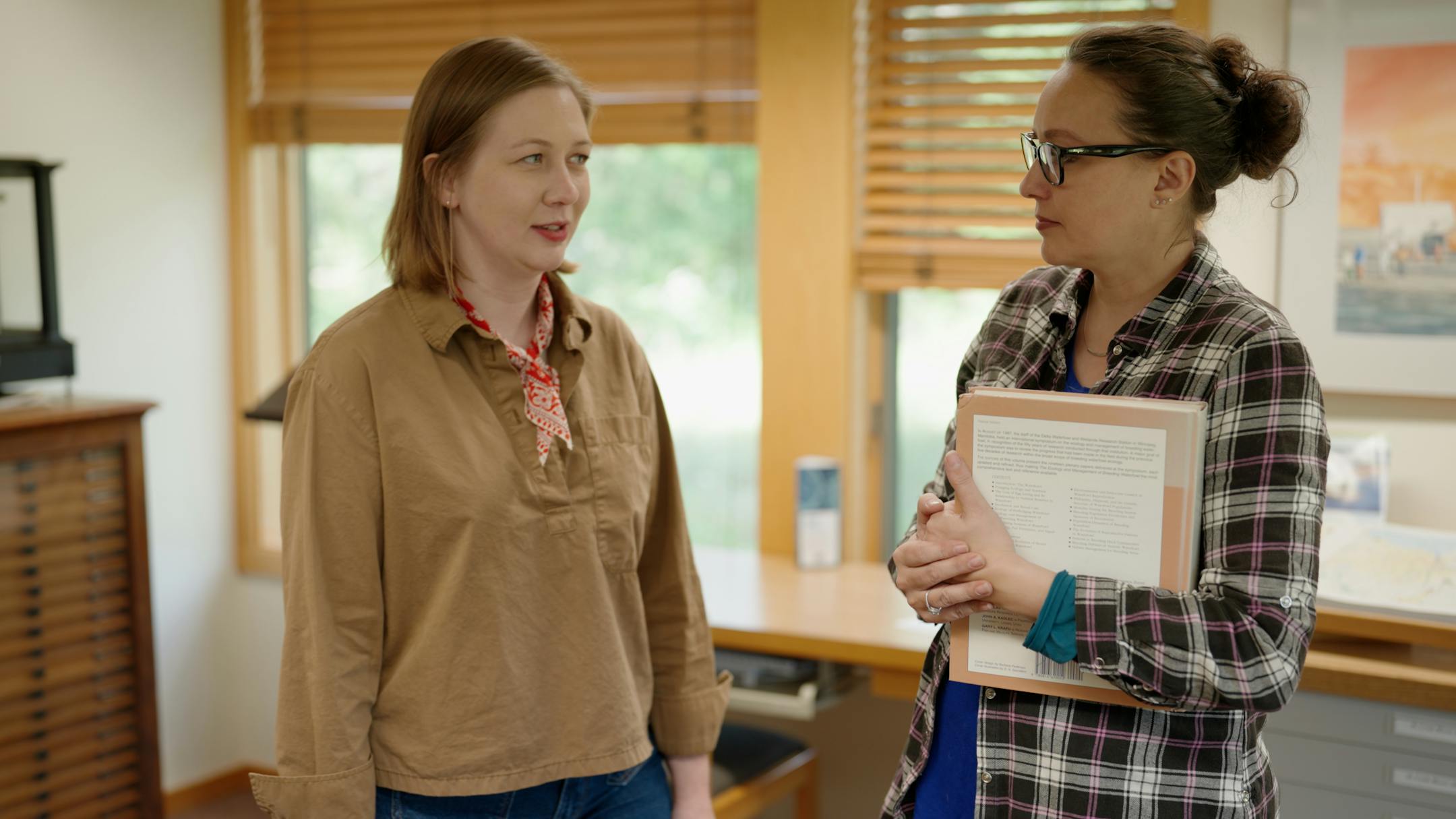 Haley Prochnow (left), artist-in-residence, and Alaina Fedie (right), Pine Needles program director, talk at the Science Museum of Minnesota’s St. Croix Watershed Research Station