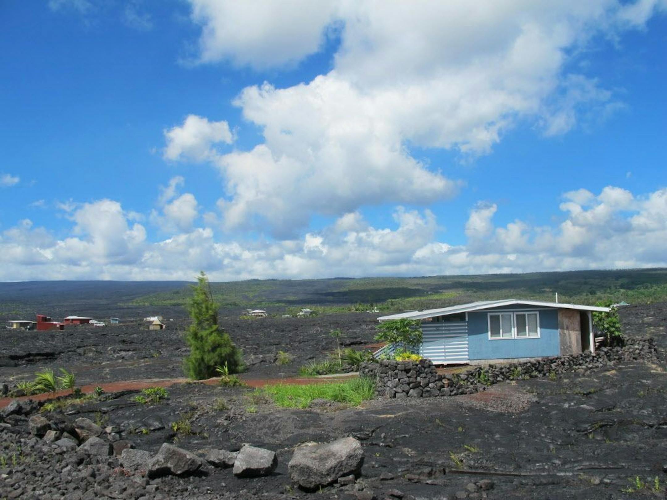 A house sits among recent lava flow in Kalapana, Hawaii on Thursday, Oct. 30, 2014.