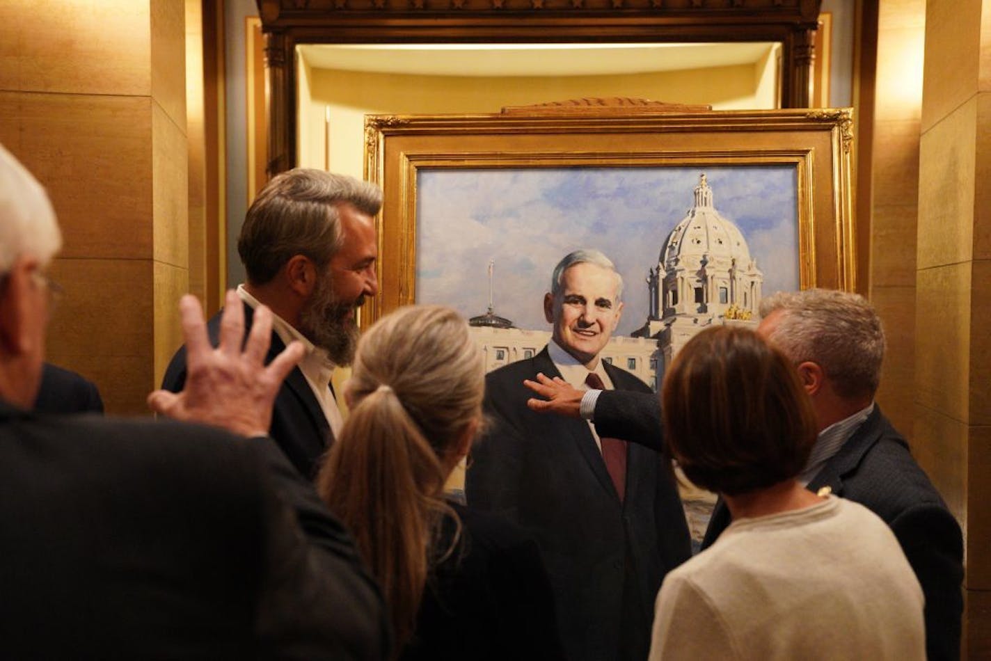 Attendees looked over former Gov. Mark Dayton's official Capitol portrait after it was unveiled during a ceremony Thursday.