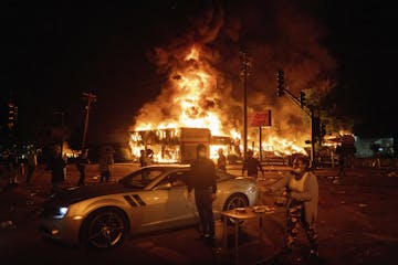 An AutoZone store burned as protesters gathered outside the Third Precinct in Minneapolis on May 28, 2020.