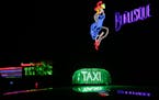 A line of taxis await visitors needing driving assistance after visiting the Chicken Bones Party Bar and Grill and Big Louie's Burlesque Saloon at the