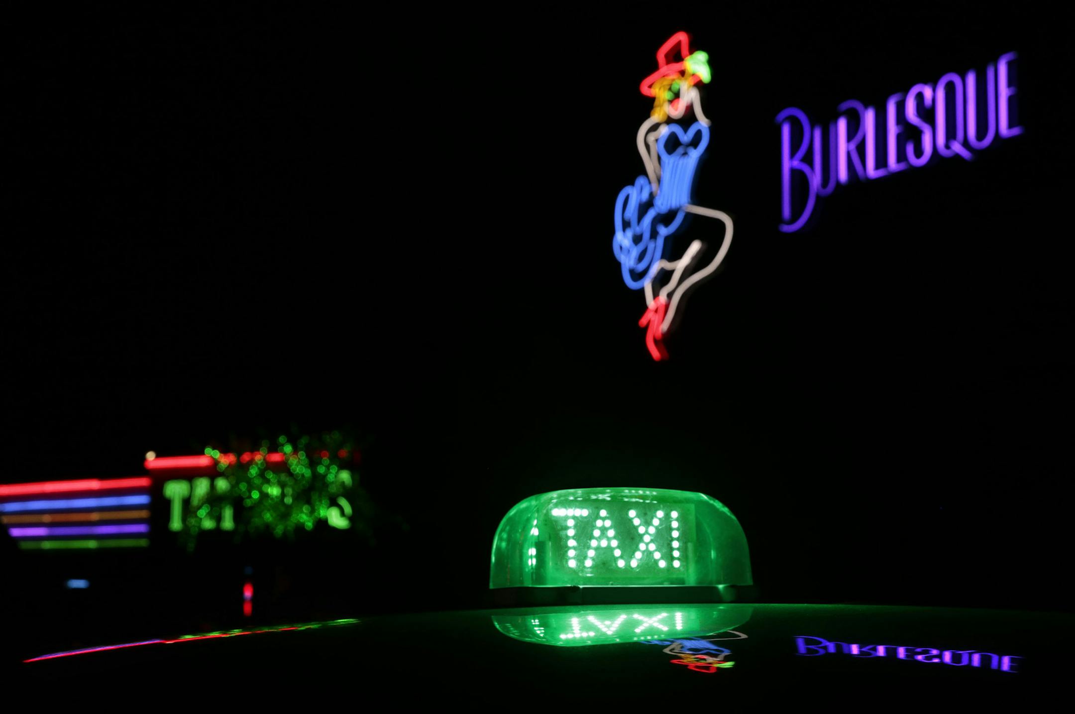 A line of taxis await visitors needing driving assistance after visiting the Chicken Bones Party Bar and Grill and Big Louie's Burlesque Saloon at the Uranus complex in Saint Robert on Friday, Sept. 29, 2017. The growing Route 66 tourist attraction hosts families by day and adults by nightfall. (Robert Cohen/St. Louis Post-Dispatch/TNS)