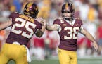 Minnesota's place kicker Emmit Carpenter celebrated after a field goal with teammate Payton Jordahl during the second quarter as Minnesota took on Mia